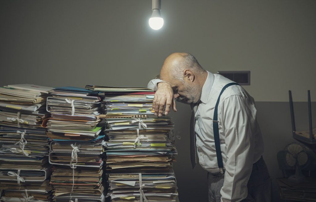 Desperate business executive with lots of paperwork